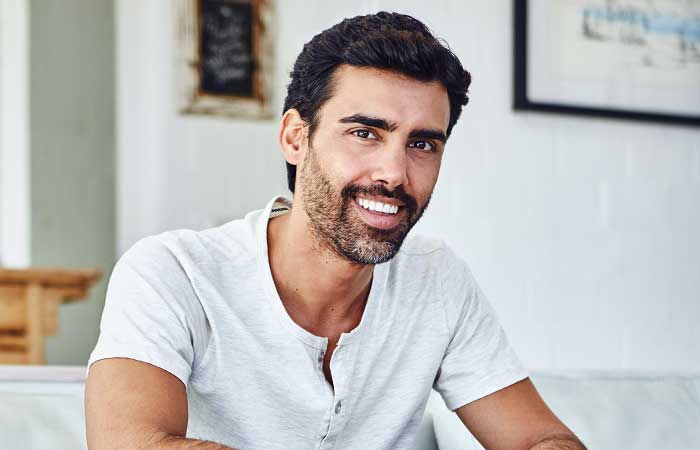 Man smiling indoors, porcelain veneers in Pryor, OK