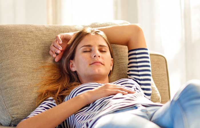 Woman relaxing on a couch, Sedation dentistry in Pryor, OK