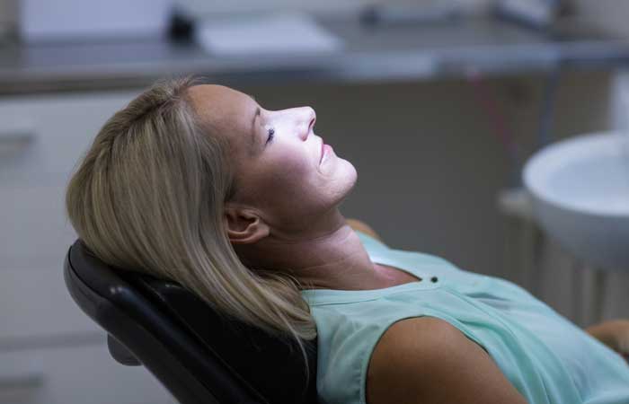 Woman relaxing in a dental chair, sedation dentistry in Pryor, OK